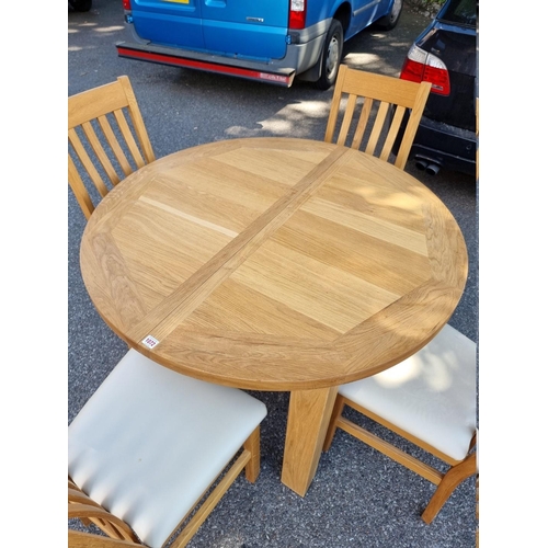 1072 - A contemporary oak 'Charltons' extending dining table; together with four matching chairs.... 