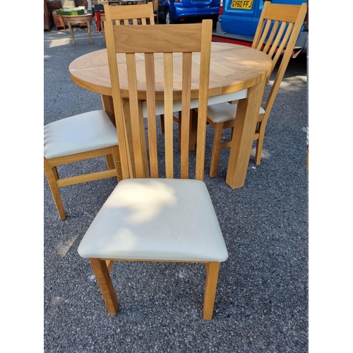 1072 - A contemporary oak 'Charltons' extending dining table; together with four matching chairs.... 