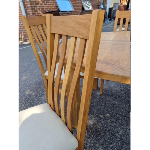 1072 - A contemporary oak 'Charltons' extending dining table; together with four matching chairs.... 