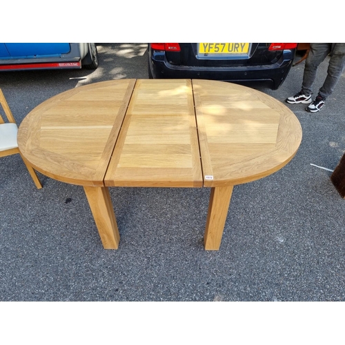 1072 - A contemporary oak 'Charltons' extending dining table; together with four matching chairs.... 