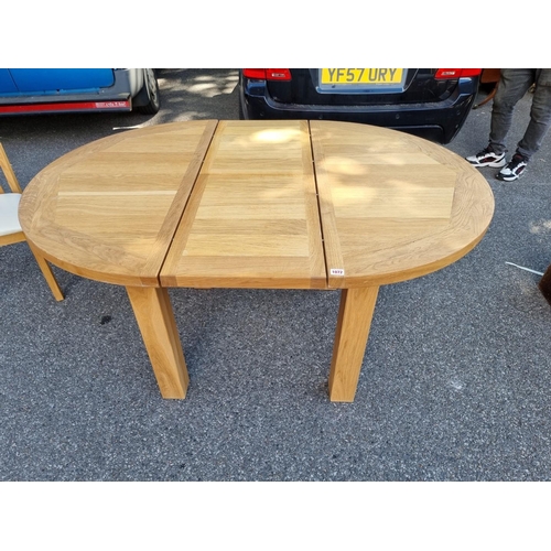 1072 - A contemporary oak 'Charltons' extending dining table; together with four matching chairs.... 