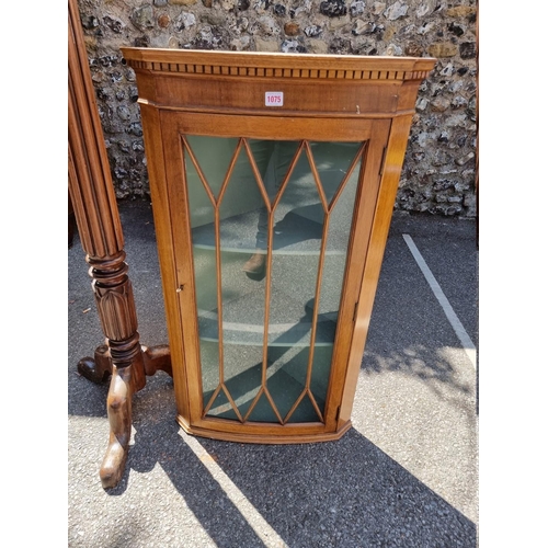 1075 - An antique hanging corner cupboard; together with a mahogany torchere.