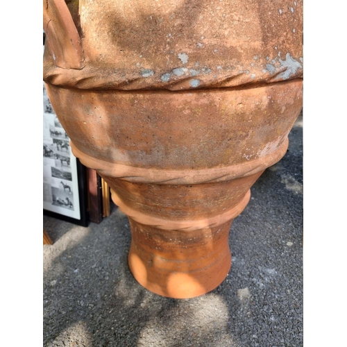 1078 - A large terracotta garden pot, 78cm high, one handle detached. 