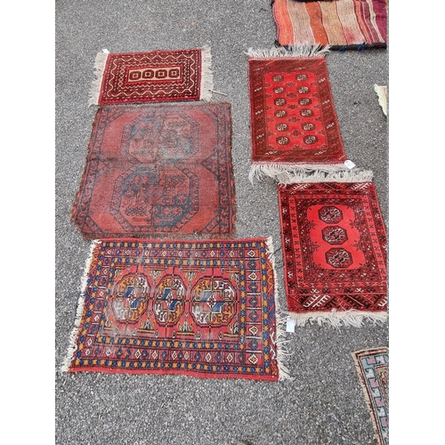 1087 - Three small Bokhara prayer mats; together with two other rugs. 