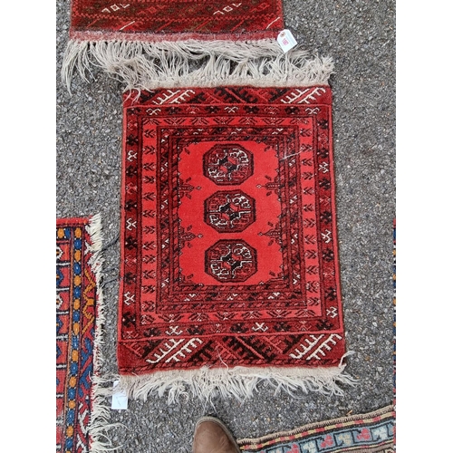 1087 - Three small Bokhara prayer mats; together with two other rugs. 