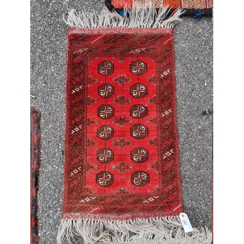 1087 - Three small Bokhara prayer mats; together with two other rugs. 