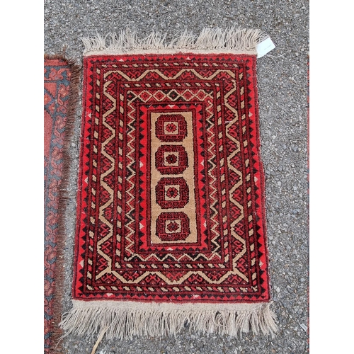 1087 - Three small Bokhara prayer mats; together with two other rugs. 