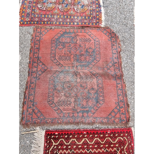 1087 - Three small Bokhara prayer mats; together with two other rugs. 