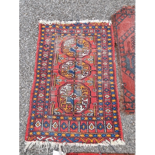 1087 - Three small Bokhara prayer mats; together with two other rugs. 