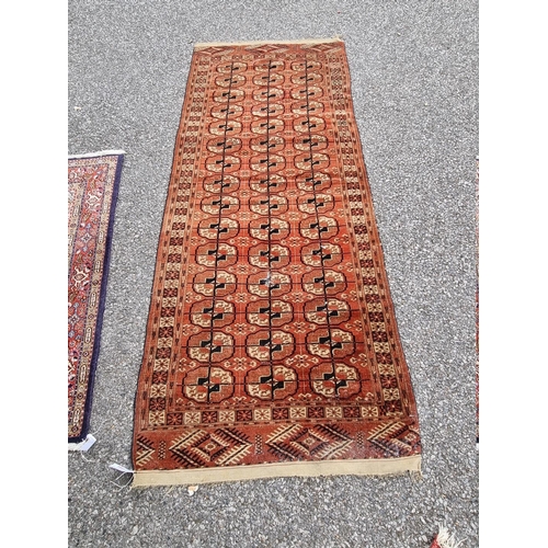 1088 - A small Bokhara runner, having repeated central field, 200cm x 82cm; together with a small floral ru... 