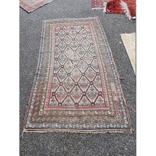 1089 - A North West Persian rug, having repeated central field, with geometric borders, 188cm x 113cm.... 