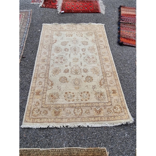 1090 - A floral rug on cream ground, 182cm x 123cm. 