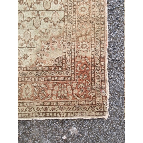 1091 - A pair of Persian rugs, having central floral medallions, with floral cartouches to each corner... 