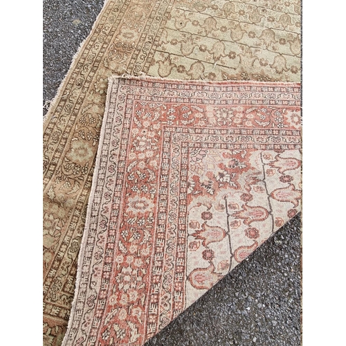 1091 - A pair of Persian rugs, having central floral medallions, with floral cartouches to each corner... 