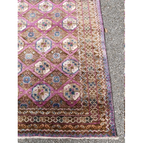 1093 - A Khyber Bokhara rug, having repeated central field on purple ground, 188cm x 98cm.