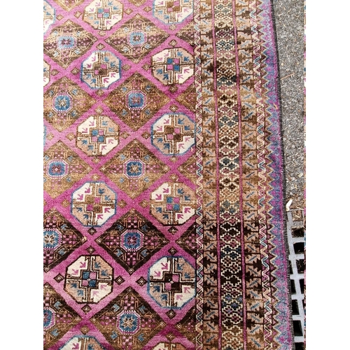 1093 - A Khyber Bokhara rug, having repeated central field on purple ground, 188cm x 98cm.