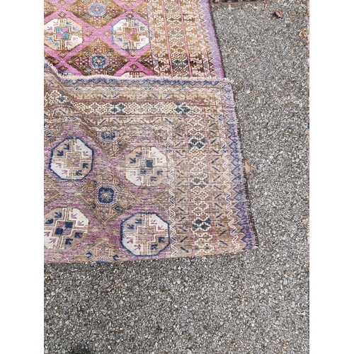 1093 - A Khyber Bokhara rug, having repeated central field on purple ground, 188cm x 98cm.