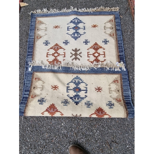 1095 - A Turkish rug, on cream ground with blue borders, 146 x 88cm.