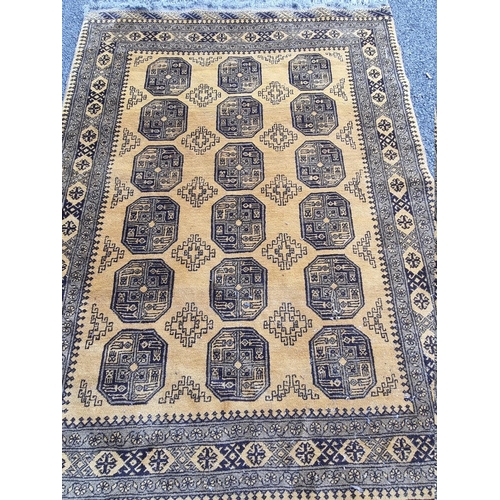 1098 - An Afghan rug, on yellow ground, 215cm x 150cm; together with another smaller Afghan rug, 188cm... 