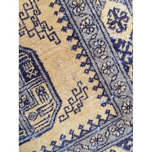 1098 - An Afghan rug, on yellow ground, 215cm x 150cm; together with another smaller Afghan rug, 188cm... 