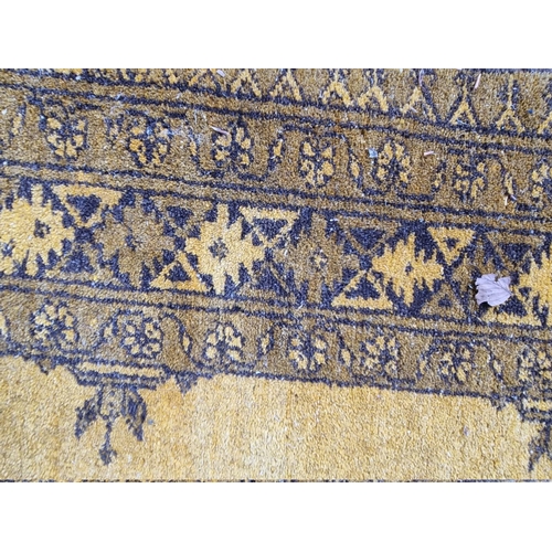 1098 - An Afghan rug, on yellow ground, 215cm x 150cm; together with another smaller Afghan rug, 188cm... 