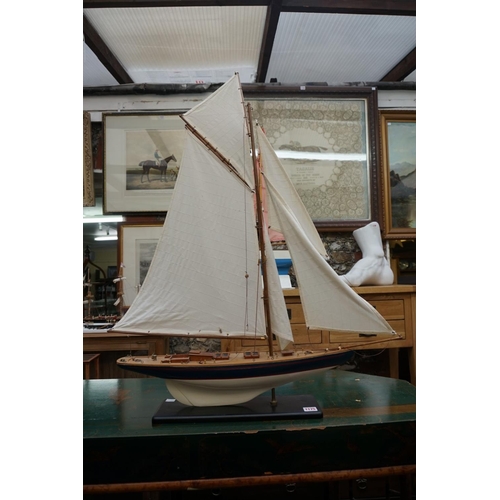 1175 - A model yacht, the hull 60cm, on fixed stand.  