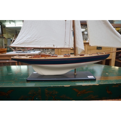 1175 - A model yacht, the hull 60cm, on fixed stand.  