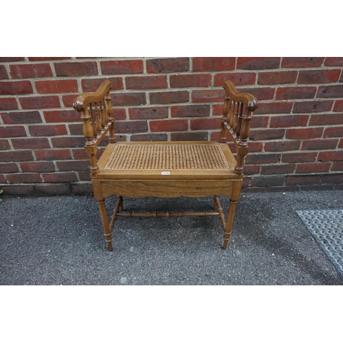 1178 - An old walnut and cane commode stool, 58.5cm wide.