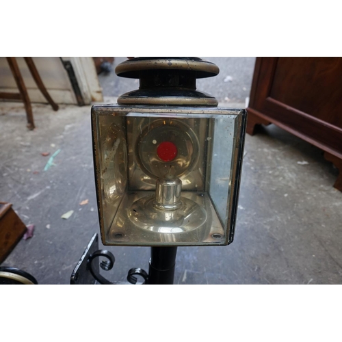 1182 - A pair of antique brass and black painted coach lamps, 57.5cm high, on metal wall brackets.&nbs... 