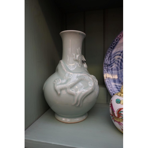 1205 - A Chinese celadon dragon vase, 26cm high, (drilled to base); together with a Japanese blue and white... 