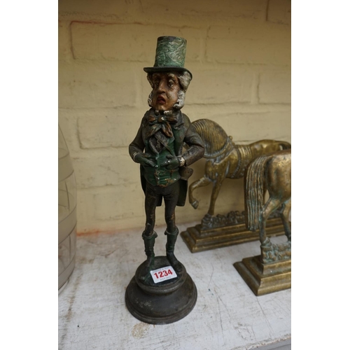 1234 - A polychrome painted metal novelty Mr Micawber candlestick, 33cm high.