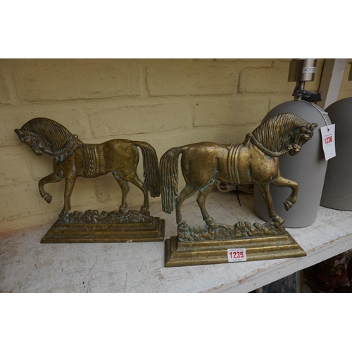 1235 - A pair of Victorian cast brass horse doorstops, 23.5cm high, (minor variations). ... 