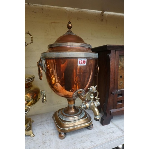 1238 - A 19th century copper and brass samovar, 44cm high; together with another brass tea urn.... 