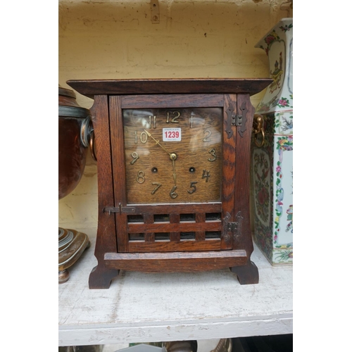 1239 - An early 20th century oak mantel clock, 35cm high, with pendulum.