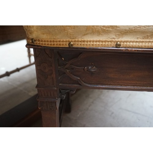 1276 - An early 20th century mahogany and blind fret duet stool, with hinged seat, 93cm wide.... 