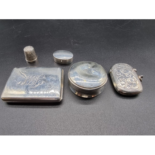 621 - A group of four silver items. to include: a vesta case; and a match book cover, gross weight 69g; to... 