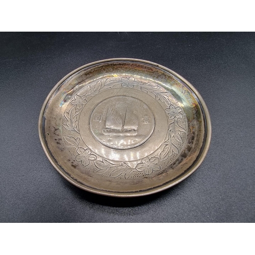 627 - A Chinese white metal ashtray, by Zee Sung, 9.5cm diameter.