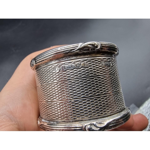 630 - Three various silver napkin rings, 82g; together with a tea strainer, stamped 800.