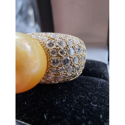 682 - A yellow metal ring, set South Sea golden pearl and pave set diamonds, stamped AK 750, size N-O, gro... 