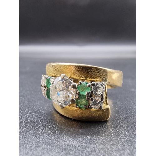 684 - A yellow metal diamond and emerald cocktail ring, set central diamond of approximately 1ct, with fou... 