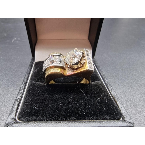 685 - A yellow metal and diamond cocktail ring, the principal stone approximately 1.2ct, set with ten othe... 