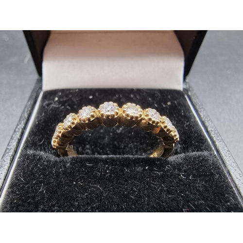 698 - A yellow metal diamond half eternity ring, stamped 14k, size N.