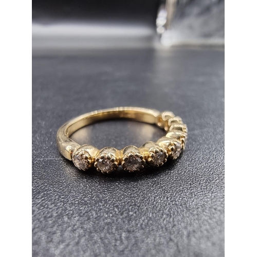 698 - A yellow metal diamond half eternity ring, stamped 14k, size N.