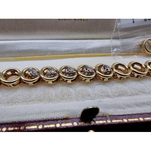 705 - An 18ct gold bracelet, having circular links, set centrally with five brilliant cut diamonds, 16.5cm... 