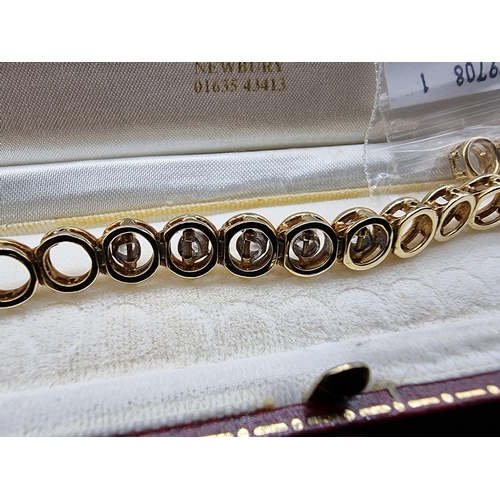 705 - An 18ct gold bracelet, having circular links, set centrally with five brilliant cut diamonds, 16.5cm... 