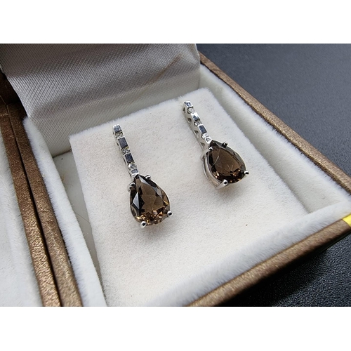 709 - A 9ct white gold pendant, set tear drop smoky quartz, 25mm, on a fine 9ct gold necklace; together wi... 