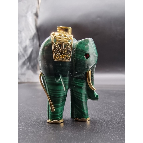 718 - A carved malachite elephant pendant, 43mm high.