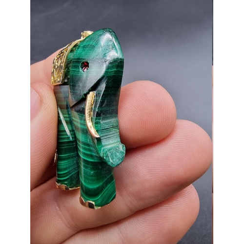 718 - A carved malachite elephant pendant, 43mm high.