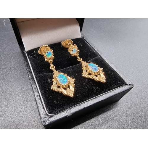 735 - A pair of yellow metal and opal pendant earrings, stamped 14k, 3cm.