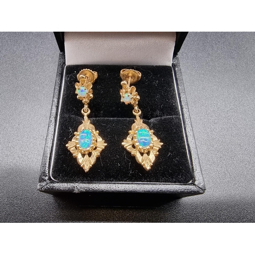 735 - A pair of yellow metal and opal pendant earrings, stamped 14k, 3cm.